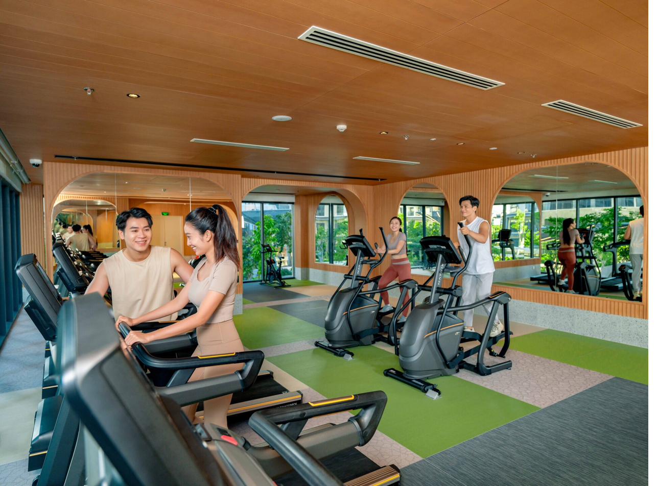 Fitness centre with cardio equipment under a timber ceiling